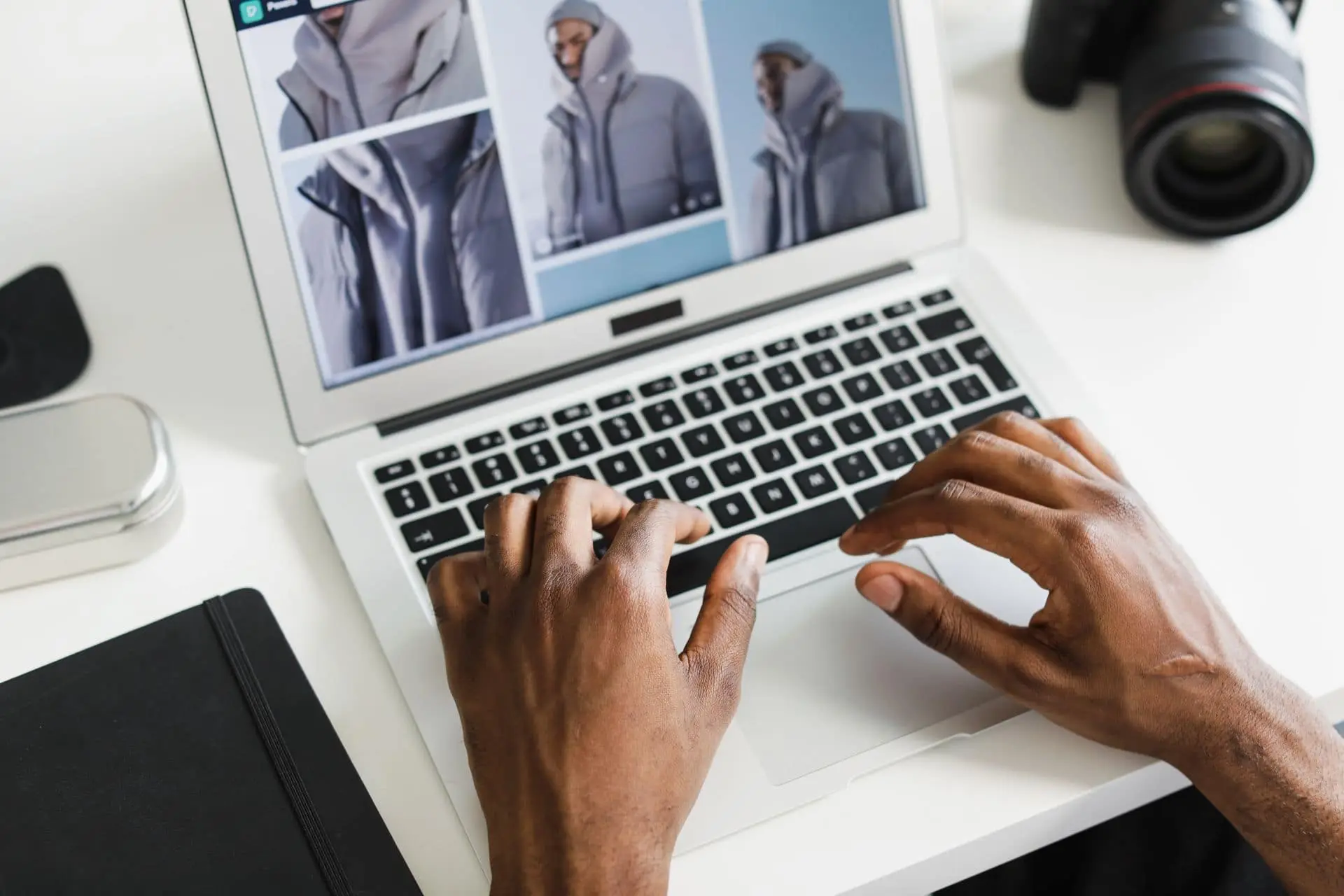 Manos trabajando en el diseño de un sitio web en una notebook